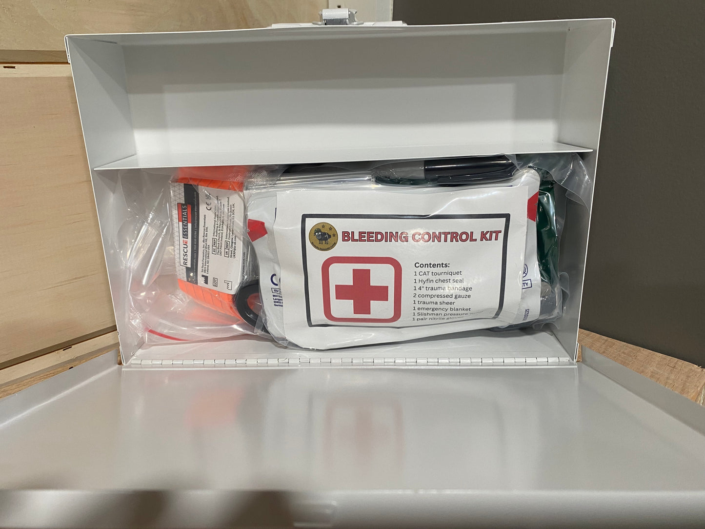 Bleeding control kit in a clear plastic vacuum sealed bag inside a metal case
