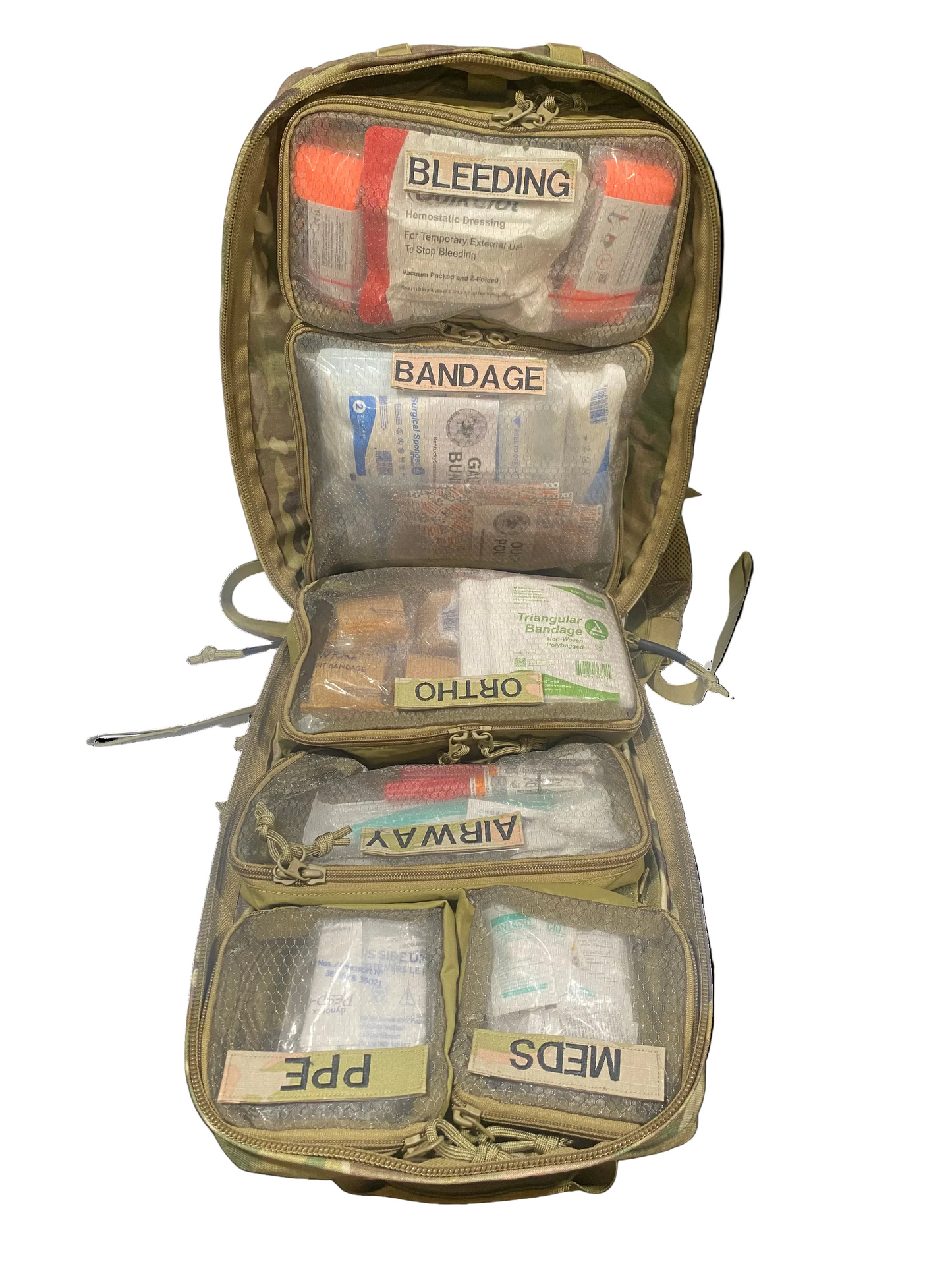 Open first aid kit with various medical supplies on a white background