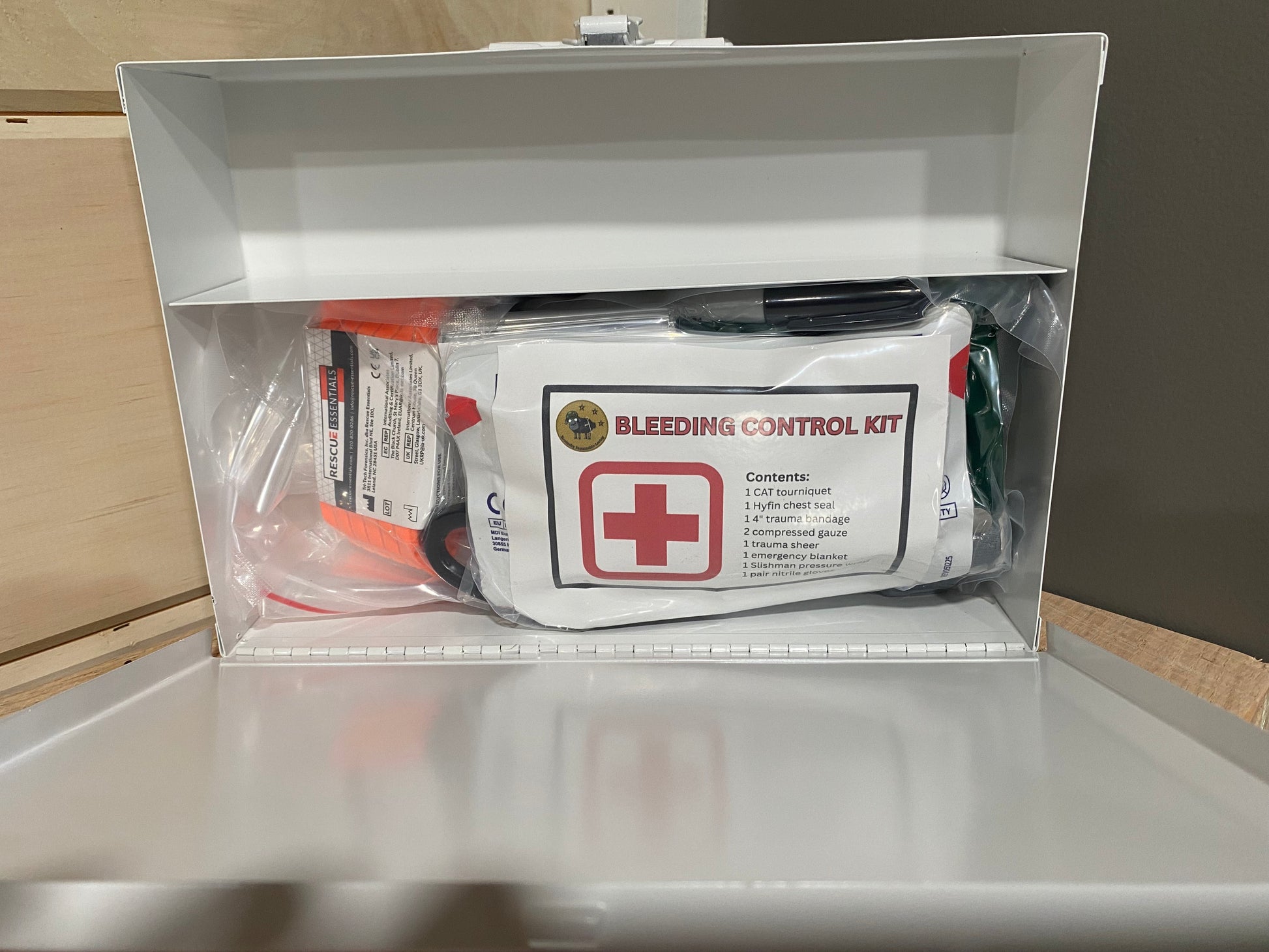 Bleeding control kit in a clear plastic vacuum sealed bag inside a metal case 