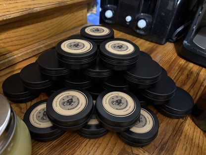 Comfrey salves in black tins with logo