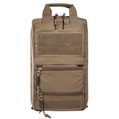 Tan backpack with multiple pockets and zippers on a white background